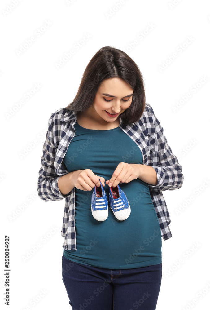 Portrait of beautiful pregnant woman with baby booties on white background Portrait of beautiful pregnant woman with baby booties on white background