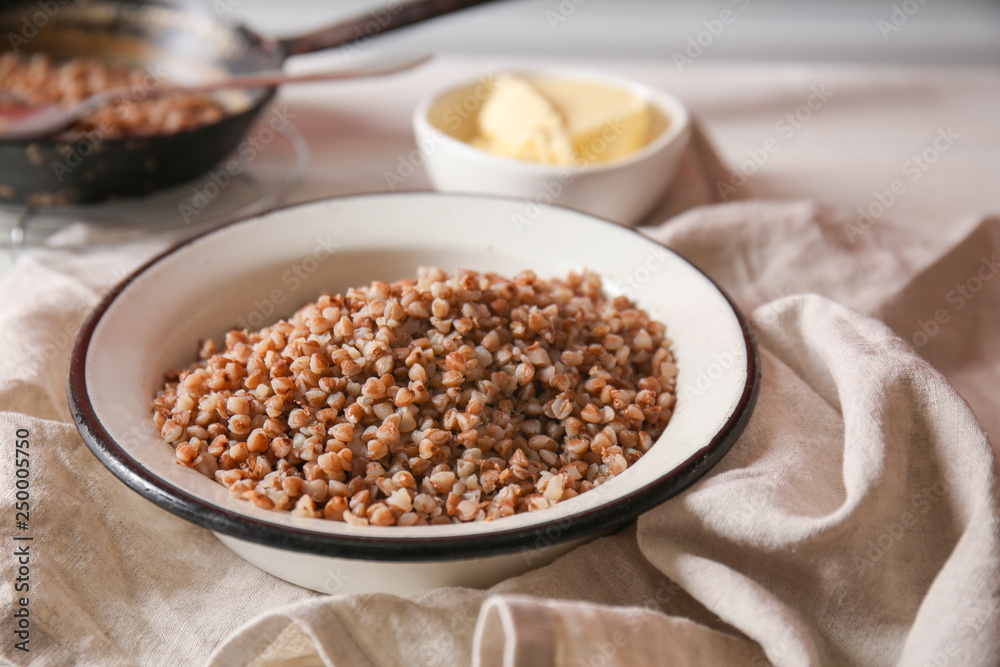 Bowl with tasty boiled buckwheat on table Bowl with tasty boiled buckwheat on table