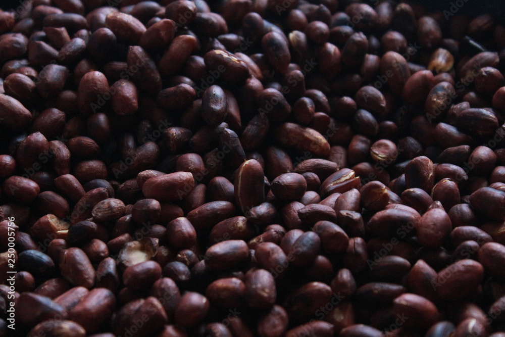 Close-up beautiful brown roasted peanuts in a pan with smoke close-up. Close-up beautiful brown roasted peanuts in a pan with smoke close-up.