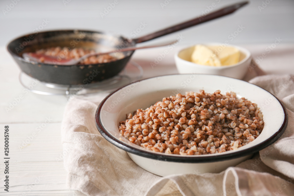 Bowl with tasty boiled buckwheat on table Bowl with tasty boiled buckwheat on table