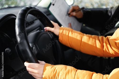 Young woman passing driving license test © Pixel-Shot
