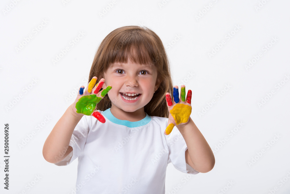 Happy smiling beautiful little girl with her colorful hands in the paint isolated on white background Happy smiling beautiful little girl with her colorful hands in the paint isolated on white background