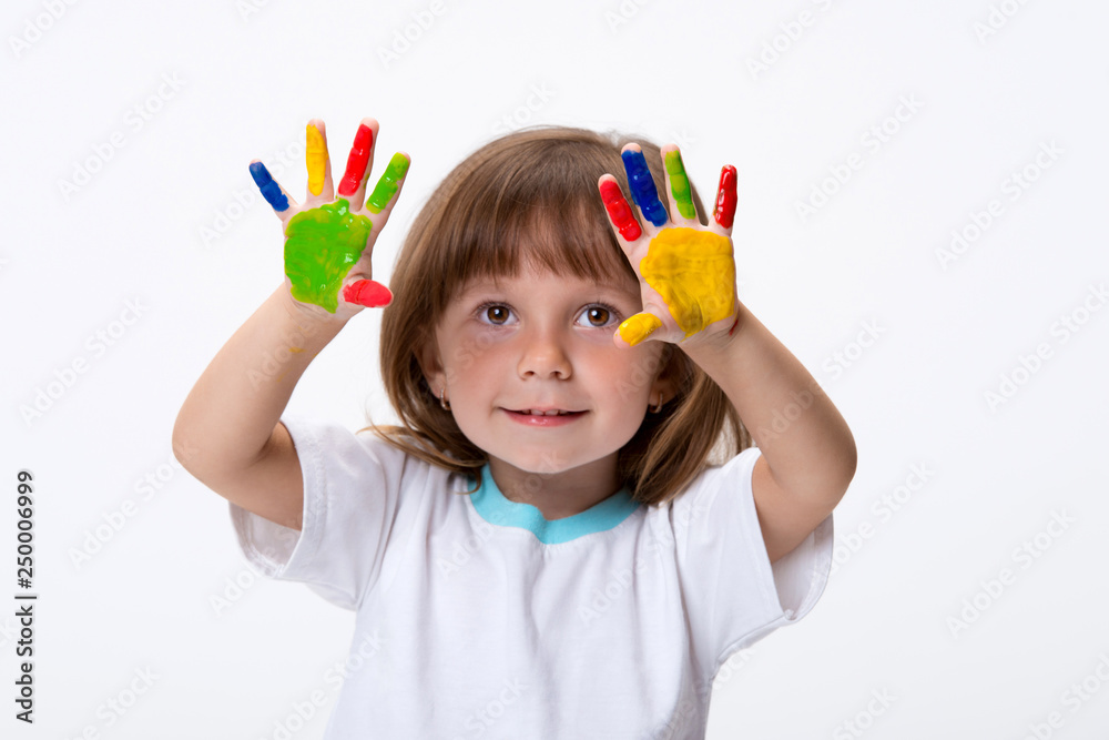 Happy smiling beautiful little girl with her colorful hands in the paint isolated on white background Happy smiling beautiful little girl with her colorful hands in the paint isolated on white background