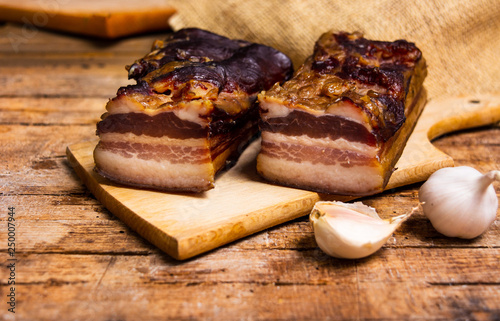 Homemade smoked pork bacon on a cutting board