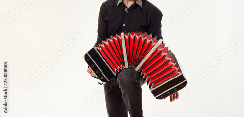 GOMEL, BELARUS - FEBRUARY 14, 2019: a bandoneon musical instrument in the hands of a musician. photo