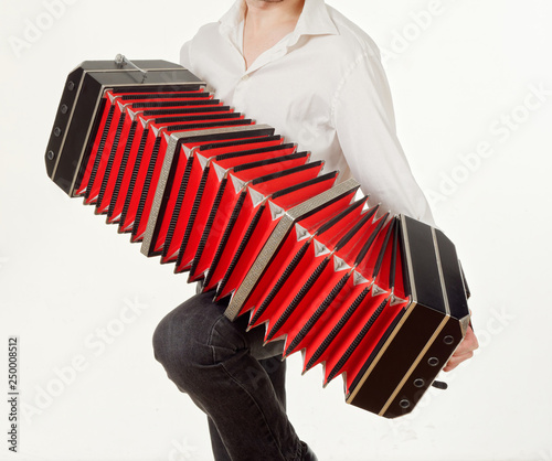 GOMEL, BELARUS - FEBRUARY 14, 2019: a bandoneon musical instrument in the hands of a musician. photo