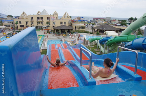 Colorful slides in tropical outdoor water park.