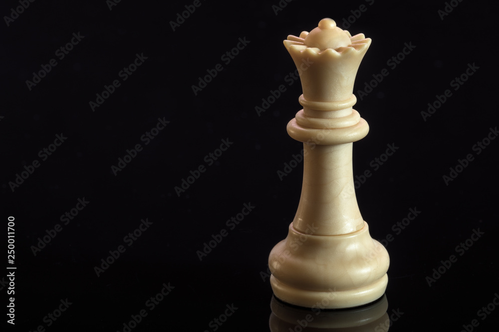 Classic Chess White Queen on black surface, isolated Classic Chess White Queen on black surface, isolated