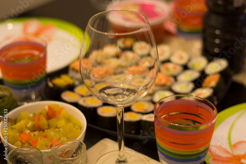 sushi colorful mix served dinner with wine, glasses, on table at restaurant, evening date, food photography