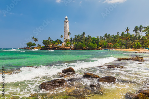 Fényképezés White lighthouse Dondra Head and tropical palms, Sri Lanka, near Matara
