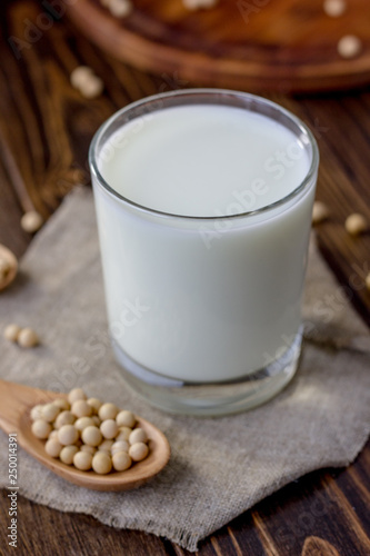 Soy milk with soy beans around it.