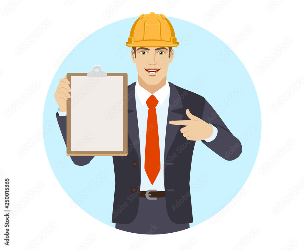 Businessman in construction helmet pointing at a clipboard Businessman in construction helmet pointing at a clipboard