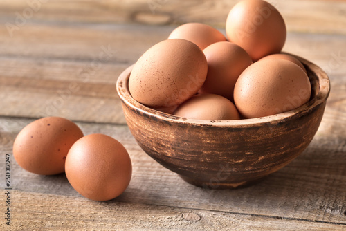 Bowl of raw chicken eggs photo