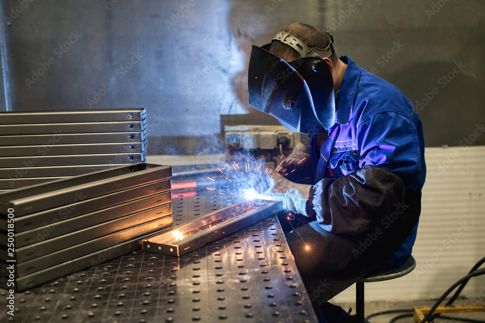 Working welder welds parts factory Working welder welds parts factory