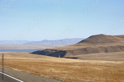 Smooth hills covered with dry grass in Khakassia, Russia