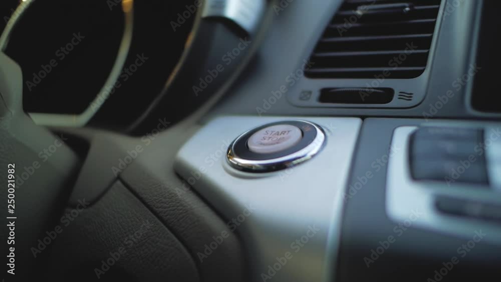 male hand presses the start button in the car male hand presses the start button in the car