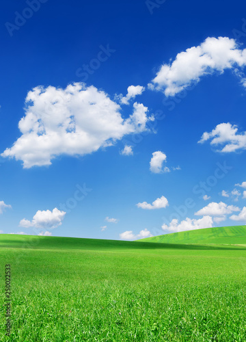 Idyllic view, green hills and blue sky with white clouds