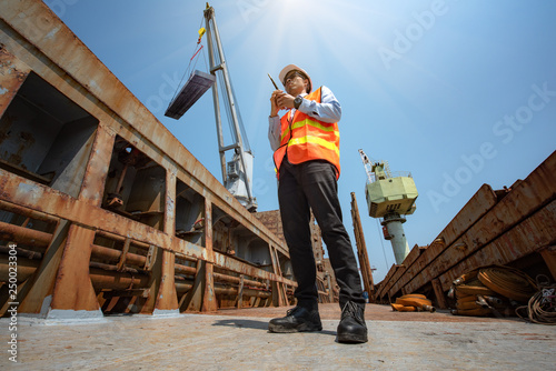 the ship crane and cargo steel bundle under loading control by stevedore, loading master, port captain or supervisor in charge of command working on board the ship in port for safety operation