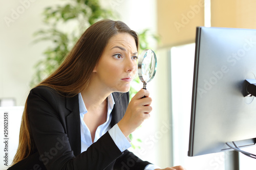 Suspicious office worker checking online content photo