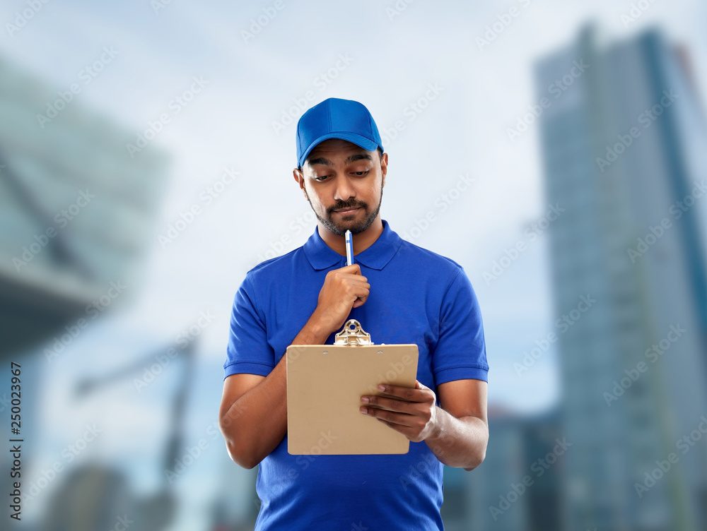 mail service and shipment concept - indian delivery man with clipboard in blue uniform over tokyo city skyscrapers background mail service and shipment concept - indian delivery man with clipboard in blue uniform over tokyo city skyscrapers background