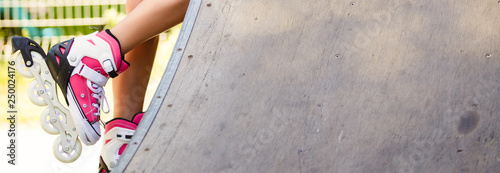 Woman's legs in a vintage roller skates. white quad roller skates. Outdoor. photo