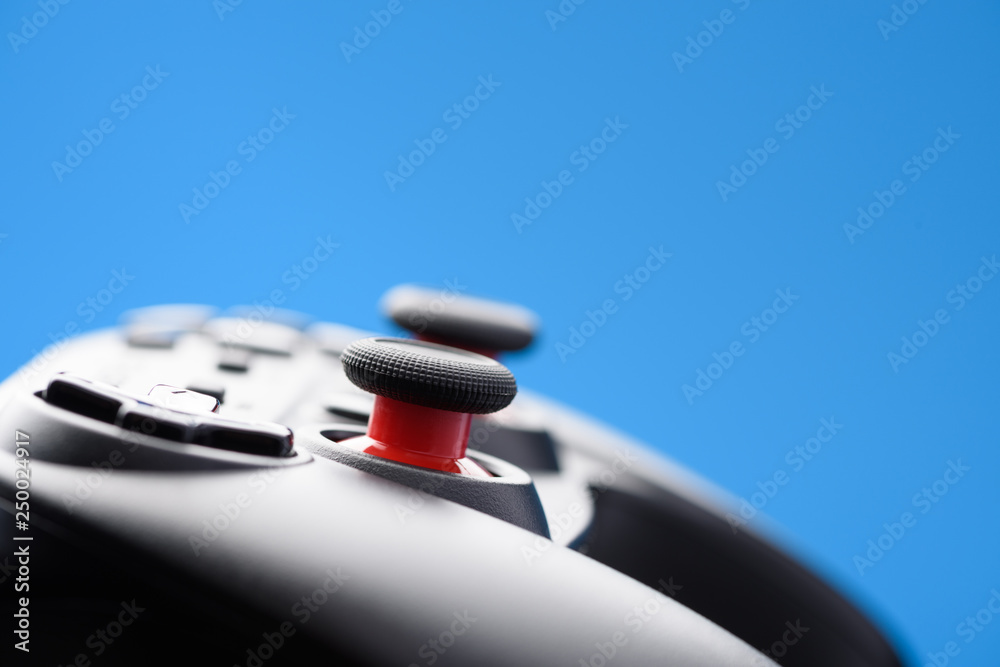 Video game controller. Game pad closeup on blue background with copy-space. Video game controller. Game pad closeup on blue background with copy-space.