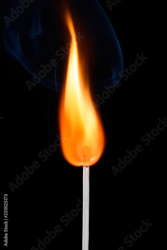 Bright burning match stick with fire and smoke isolated on black background © nevodka.com