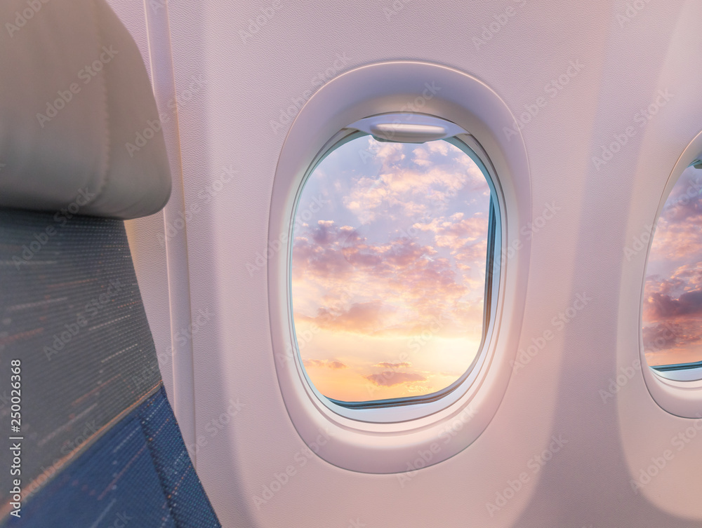 Fotografie Beautiful sunset with cloudy sky from the airplane window.