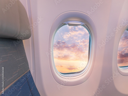 Beautiful sunset with cloudy sky from the airplane window.