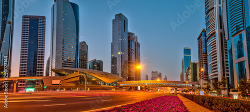 Photography Dubai skyline during sunrise with shining traffic road, United Arab Emirates
