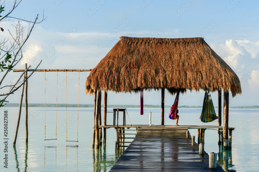 Ταπετσαρία A couple on hammocks under a palapa at Caribbean