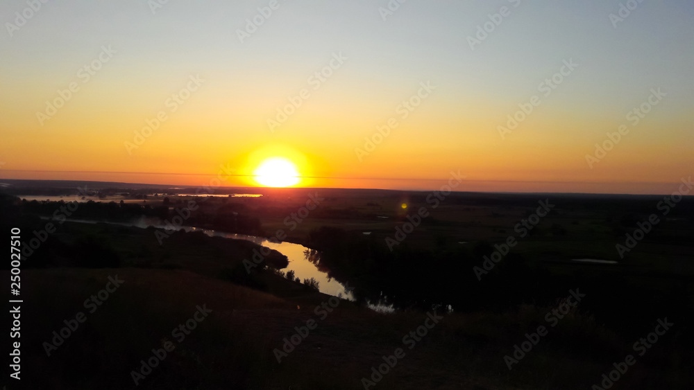 Sunset over wheat field. Landscape View of Farm Land during sunset. Border region of Ukraine near to Russia Sunset over wheat field. Landscape View of Farm Land during sunset. Border region of Ukraine near to Russia