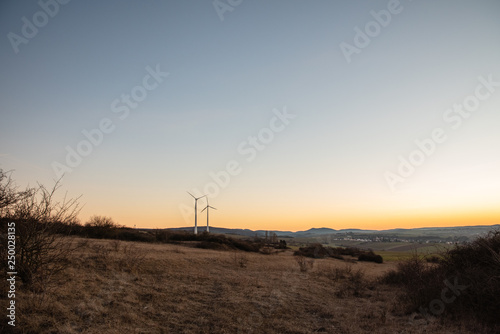 wind turbines at sunset