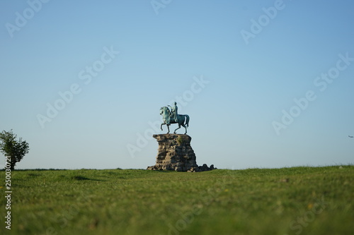 statue of man on horse with clear blue sky in background - windsor