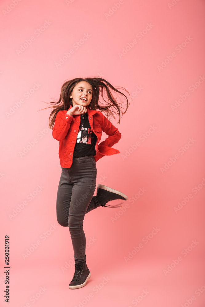 Full length photo of caucasian girl in casual dancing and laughing, isolated over red background