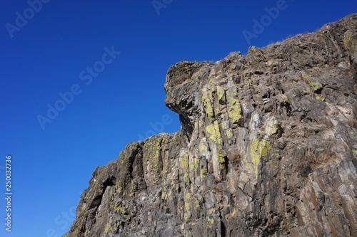 Mountain cliffs on the bank of the river against the blue sky