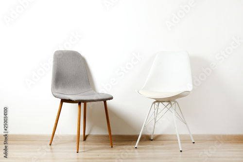 Empy loft style chair over blank wall background wit a lot of copy space for text. Available job position, interview or negotiations concept. photo