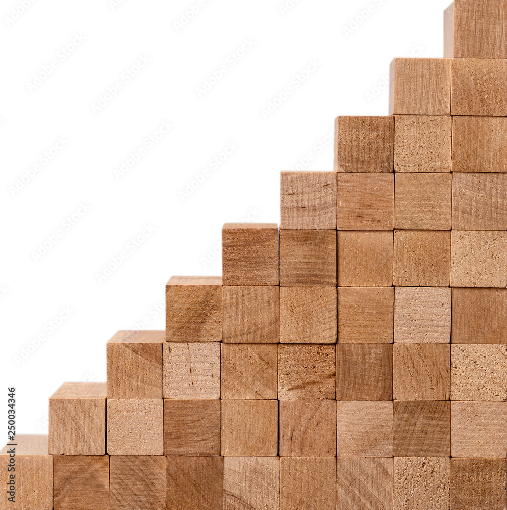Wall of wooden bricks isolated on white background. Concept: stable development