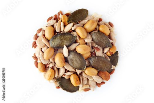 Mix of various healthy seeds including soy beans, sesame, pumpkin and sunflower seeds isolated on white background