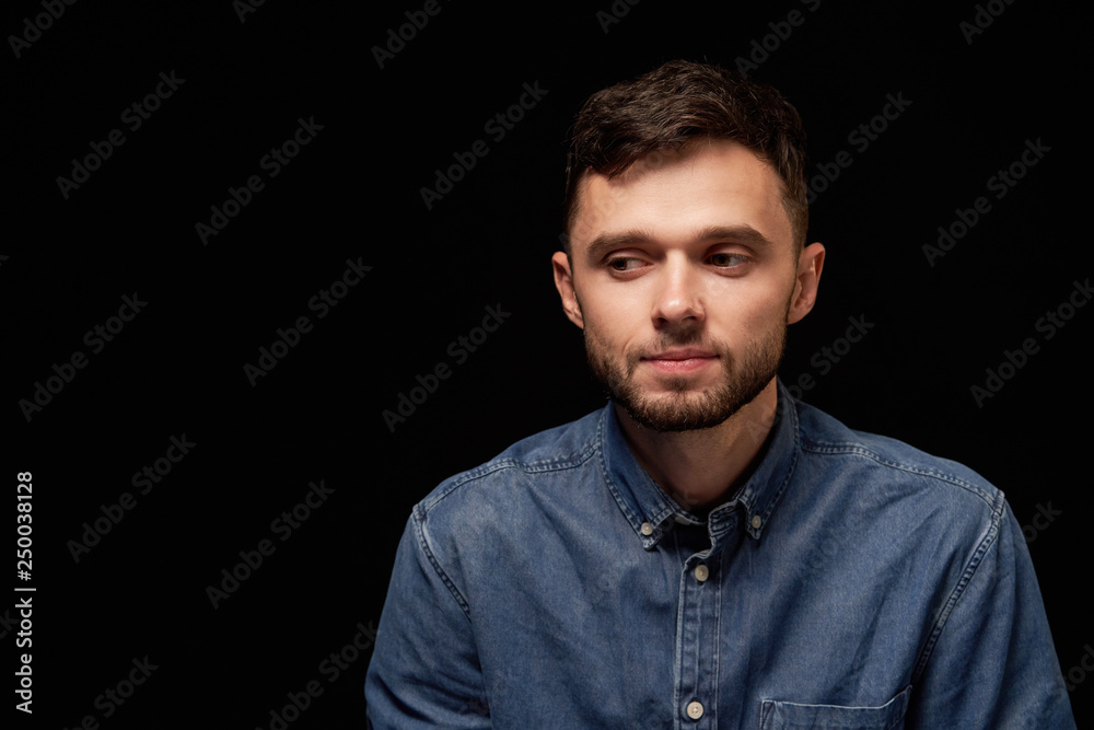 Thinking man in denim shirt looking sideways Thinking man in denim shirt looking sideways