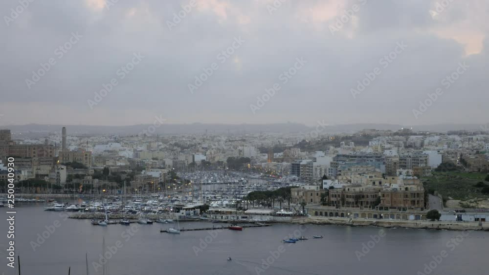 Shot of the Ferry Terminal in Sliema from Valetta, Malta, boats night