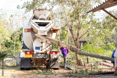 Mixer truck transport cement to the falsework of small building on the construction