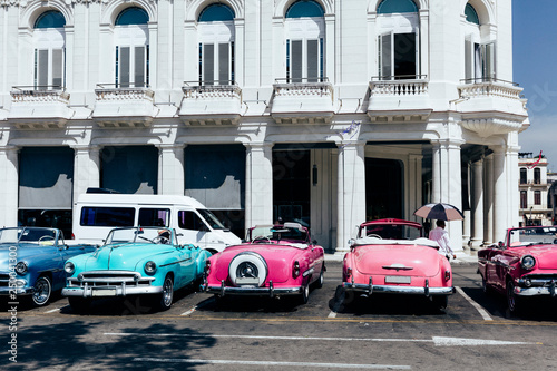 Vintage american cars parked on the street near Central Park in downtown Havana, © Zstock