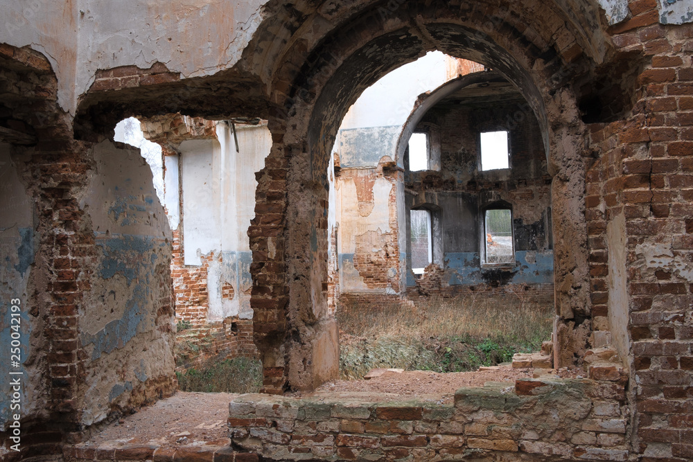 inside the ruined Church in Russia, old brick walls, shabby ceilings, fallen paint Windows