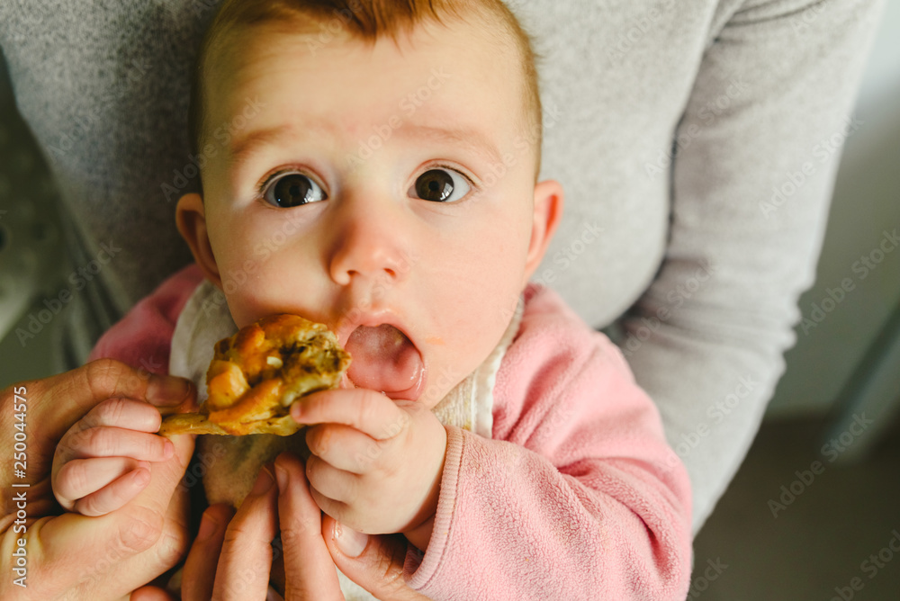 5 month old baby eating a chicken leg using the Baby led weaning BLW method. 5 month old baby eating a chicken leg using the Baby led weaning BLW method.