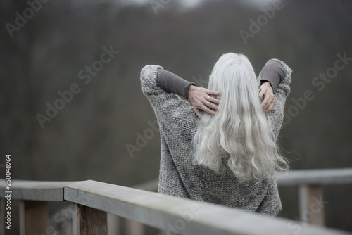 mature lady with long grey hair from the backside photo