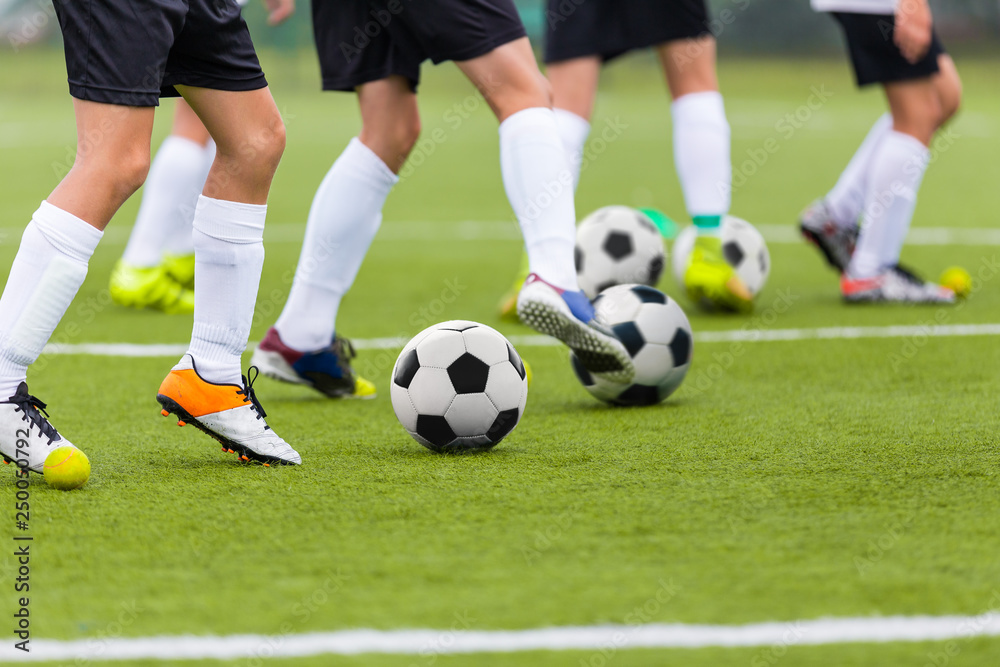 Football Soccer Training Drills: Young Players Practicing Soccer Run with Ball. Soccer Training on Fresh Grass Field Football Soccer Training Drills: Young Players Practicing Soccer Run with Ball. Soccer Training on Fresh Grass Field