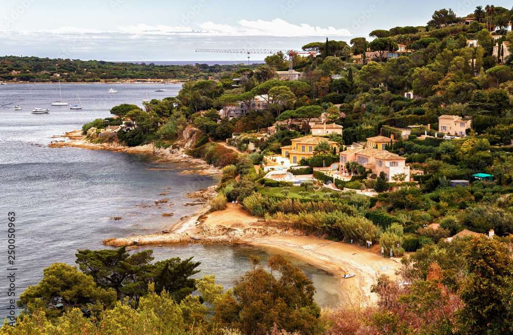 Panoramic view of Cote d'Azur picturesque coastline and green landscape with luxurious villas and yachts in Saint Tropez, Southern France. Holidays in France.