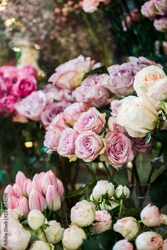 Selective focus of various colorful roses and tulips