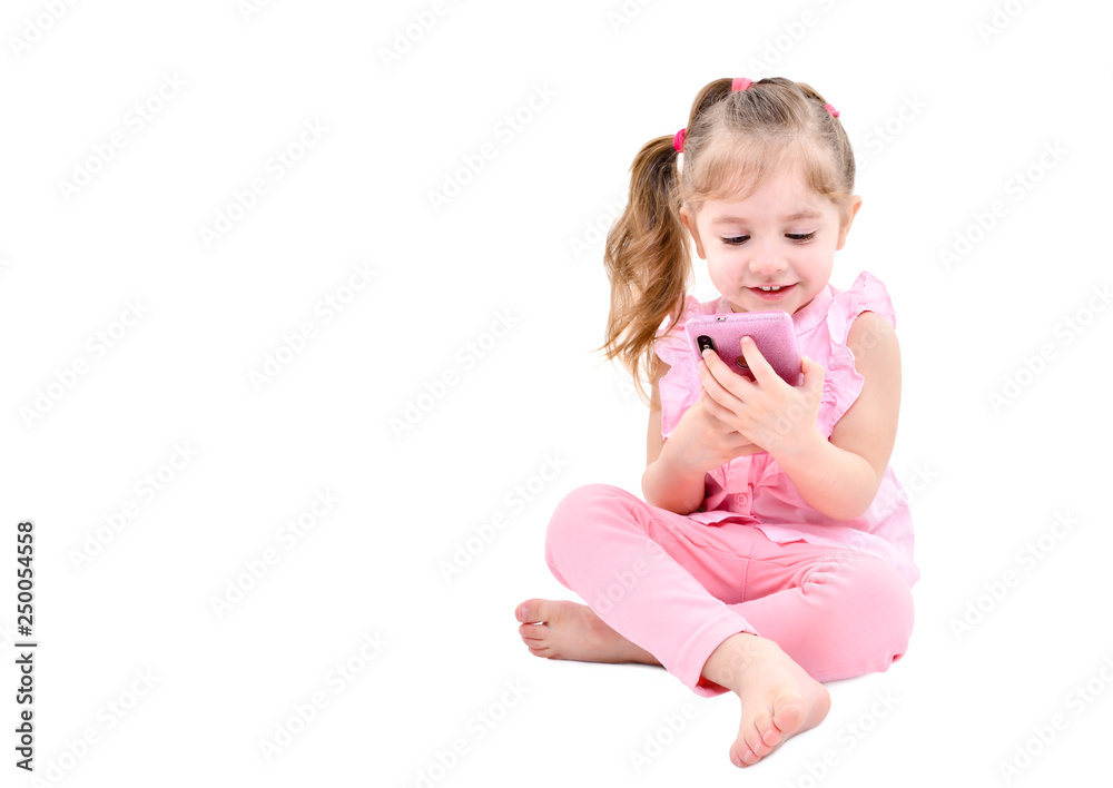 Cute little girl sitting with mobile phone isolated on white background Cute little girl sitting with mobile phone isolated on white background